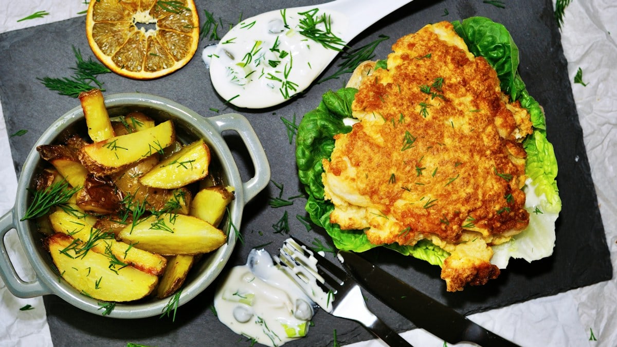 a plate of food on a table with utensils